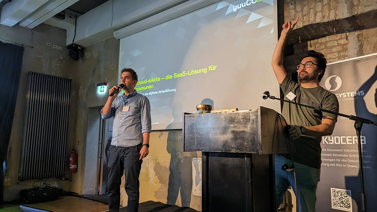 Two men standing at a podium and giving a presentation.