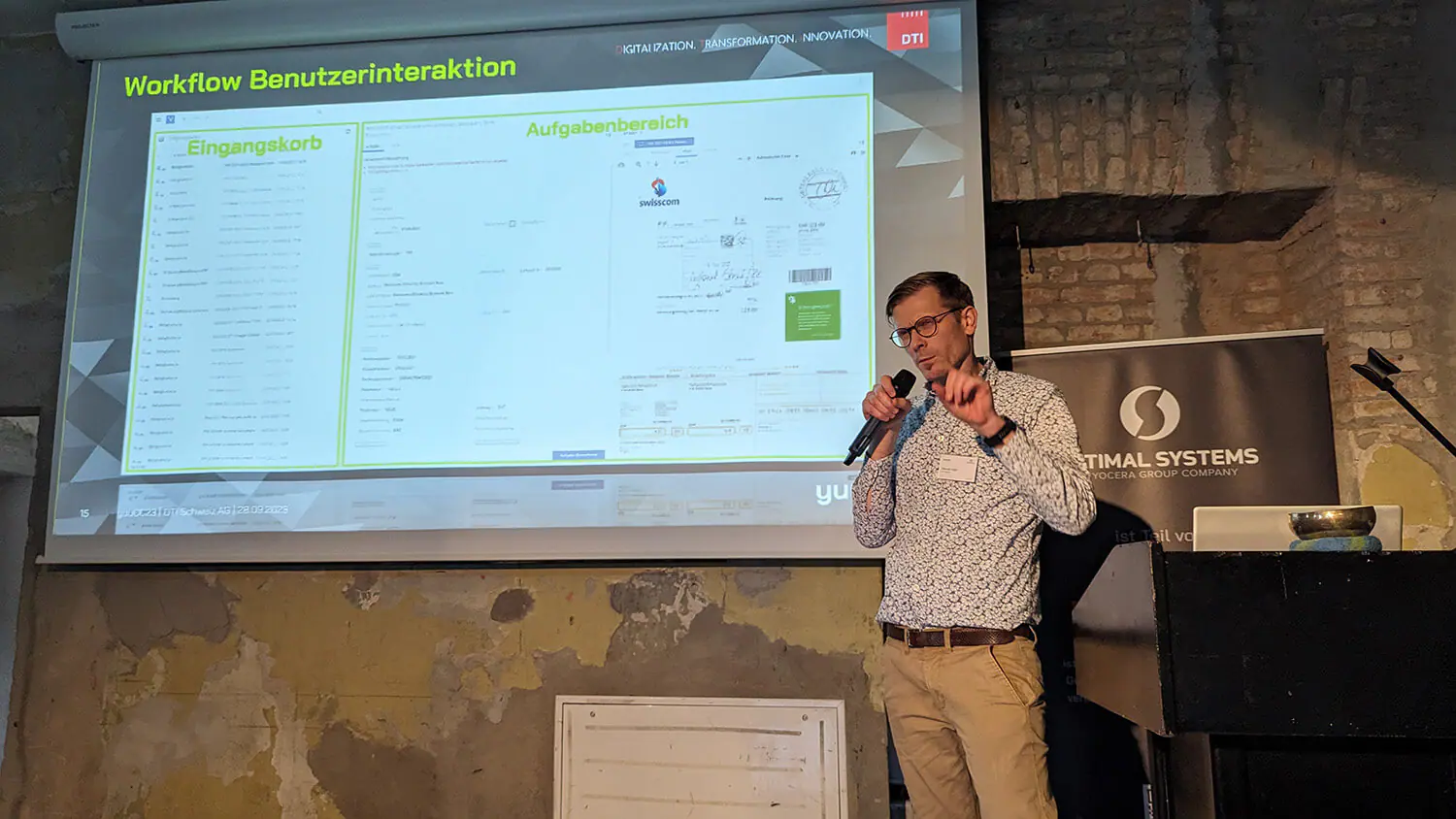 A man giving a presentation in front of a screen.