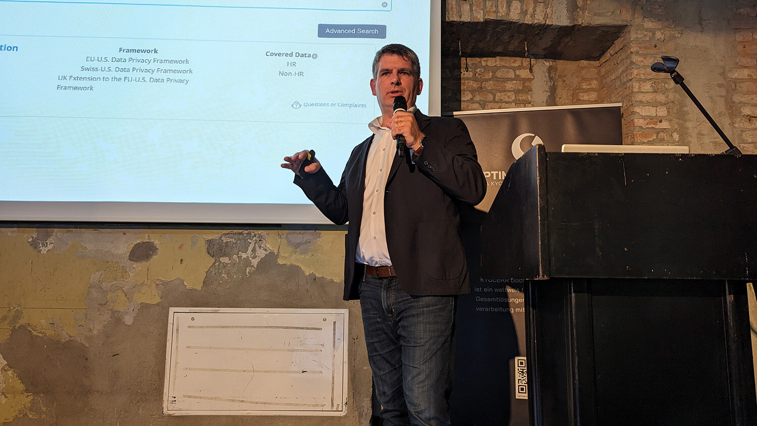 A man giving a presentation in front of a screen.