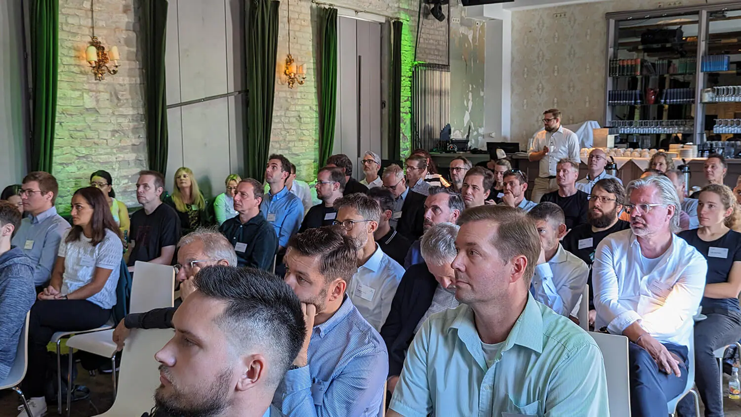 A large group of people sitting in a room.