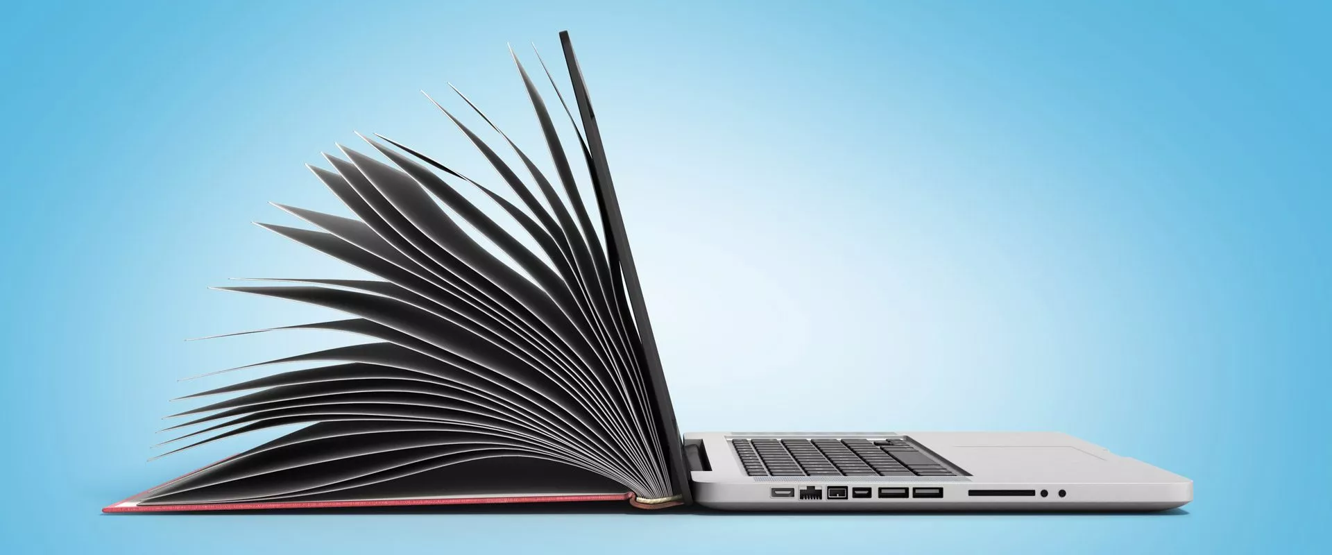 Ein Laptop, das in ein aufgeschlagenes Buch übergeht