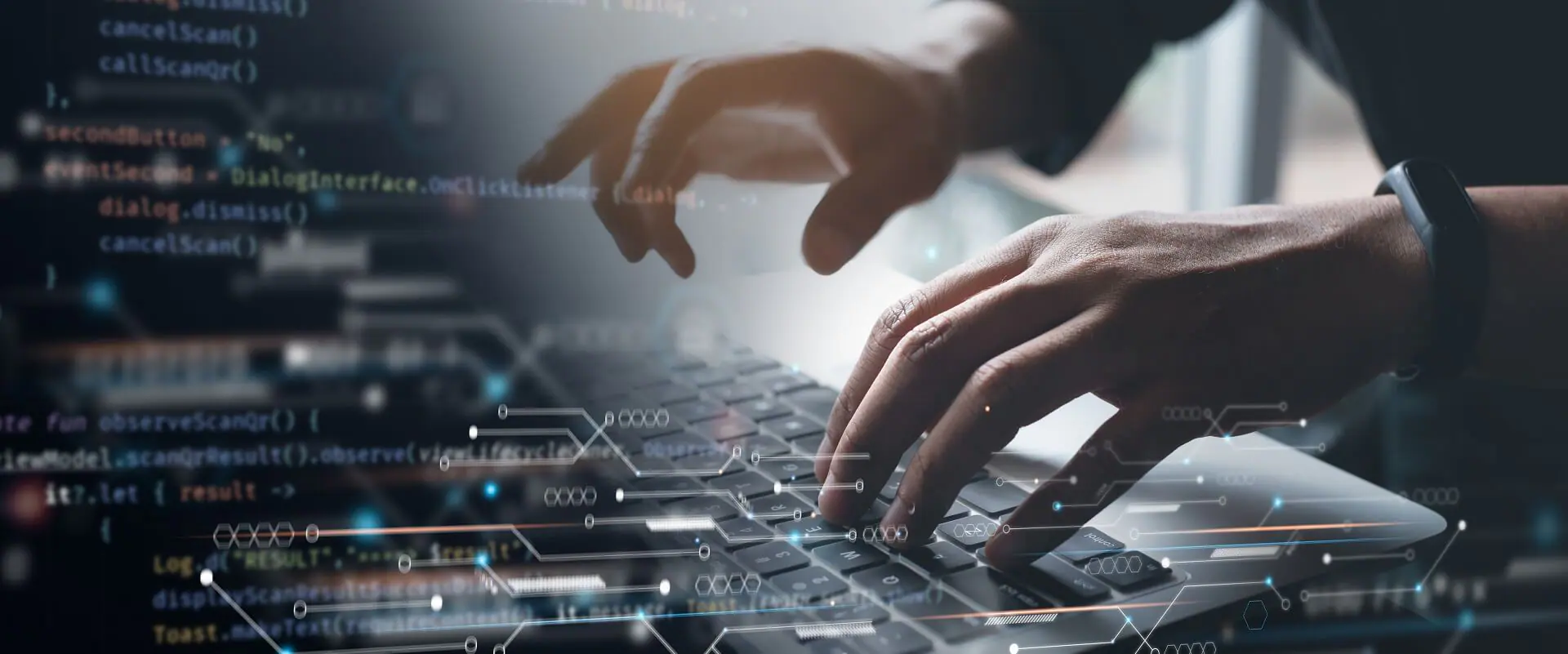 Close-up of hands typing on a laptop keyboard, with code and digital circuits as an overlay