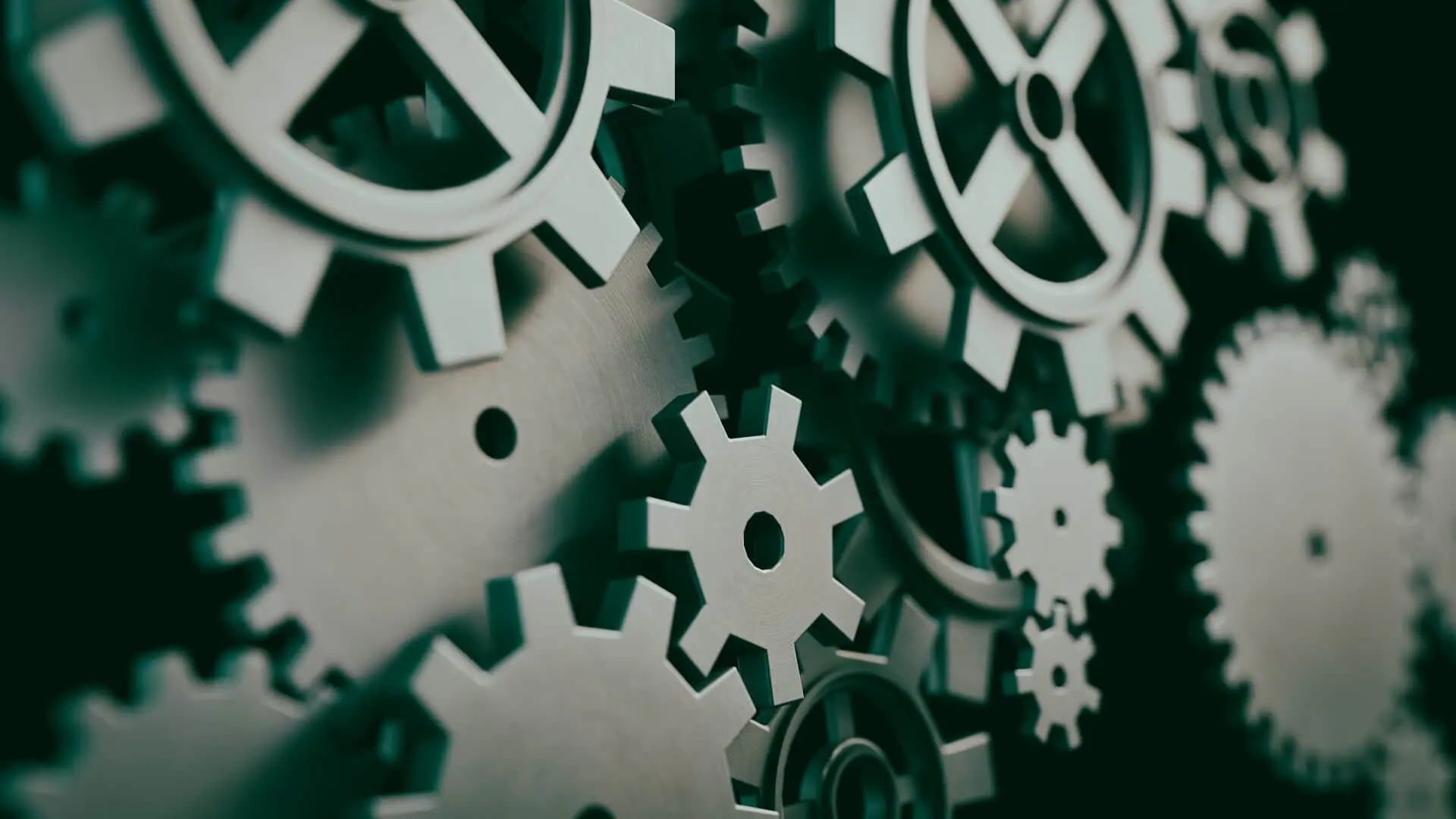 A close-up image of multiple interlocking gears of various sizes.